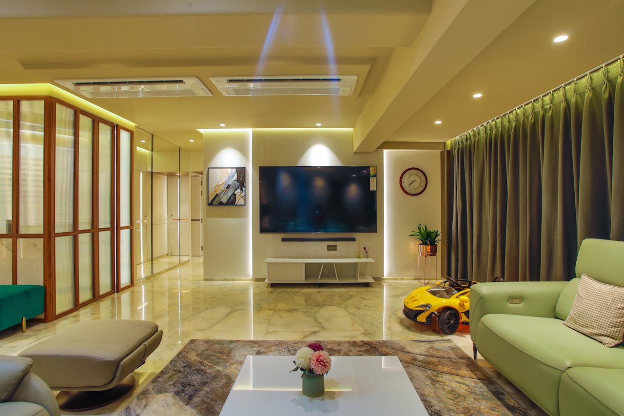 Elegant living room with modern interior design, featuring marble floors and ambient lighting.