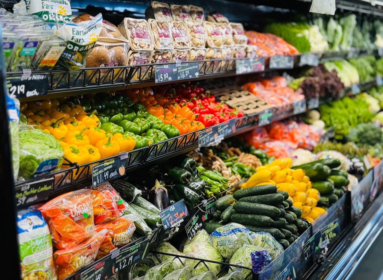Vibrant variety of fresh vegetables and fruits on grocery store shelves, showcasing healthy choices.