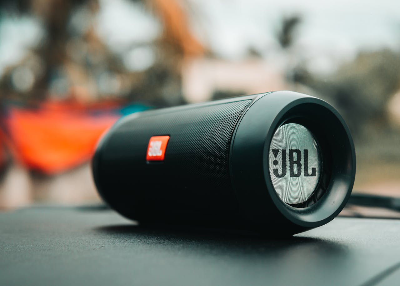 Focused shot of a black JBL portable speaker on a surface, ideal for technology concepts.
